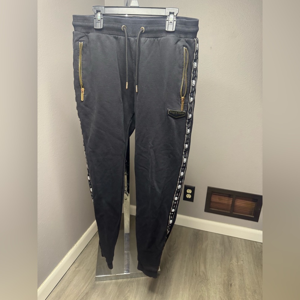 Men's Black supply and demand Joggers with Side Logo  and Gold Accents